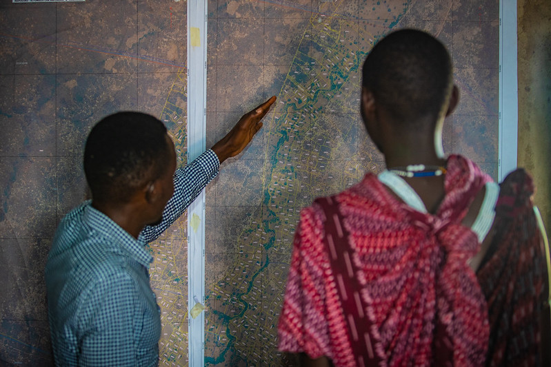 Two men looking intently at a map.