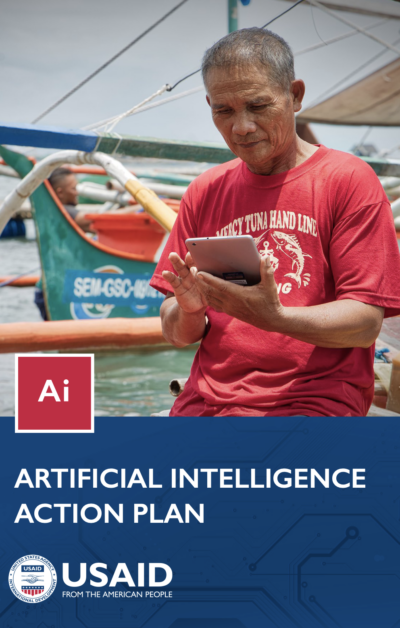 A man looking at his device while on a boat. Cover photo for the USAID Artificial Intelligence Action Plan.