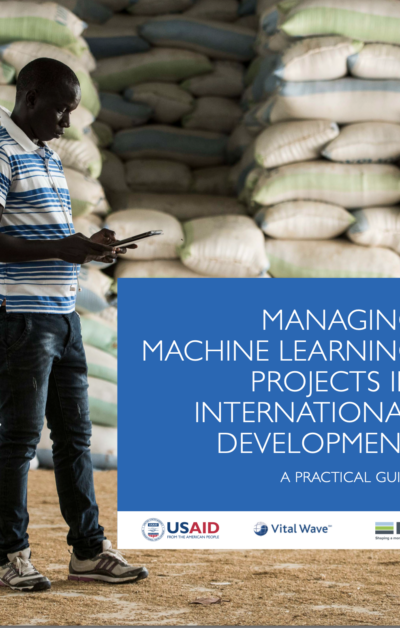 Man looking at a smart phone on the cover of USAID's Managing Machine Learning Guide.